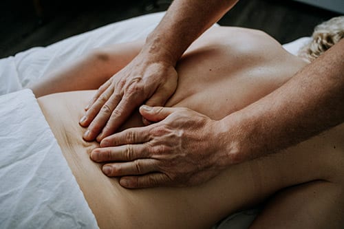Hands massaging back